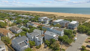 A coastal residential area with houses, a beach, and a clear view of the ocean. - Enjoy your vacation at the Triple Wave Rider (Virginia Beach)
