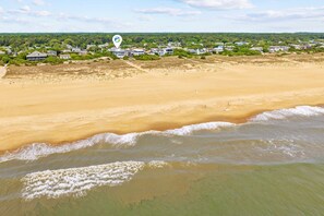 A coastal landscape with a sandy beach and ocean waves. - Enjoy your vacation at the Triple Wave Rider (Virginia Beach)
