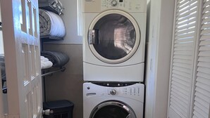 A laundry room with two stacked washing machines and a drying rack. - Get away to Green Pastures #6 .10 min drive to Beach, Great for weekend getaways (Nassau)
