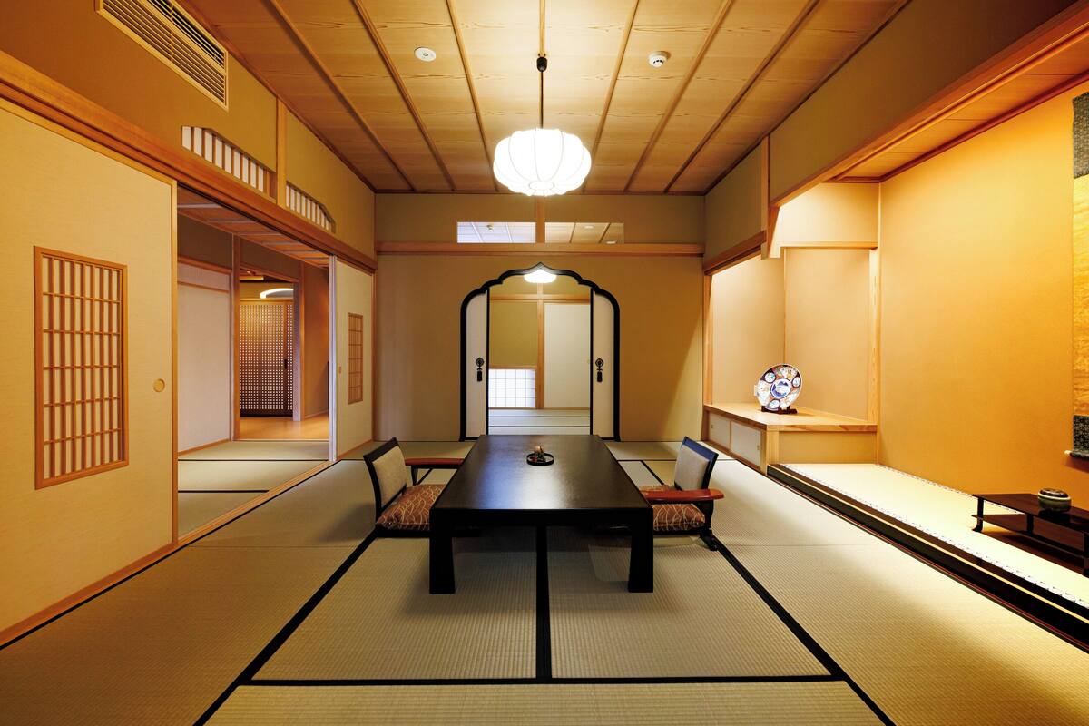 A traditional Japanese room with tatami flooring, a low table, and shoji screens.