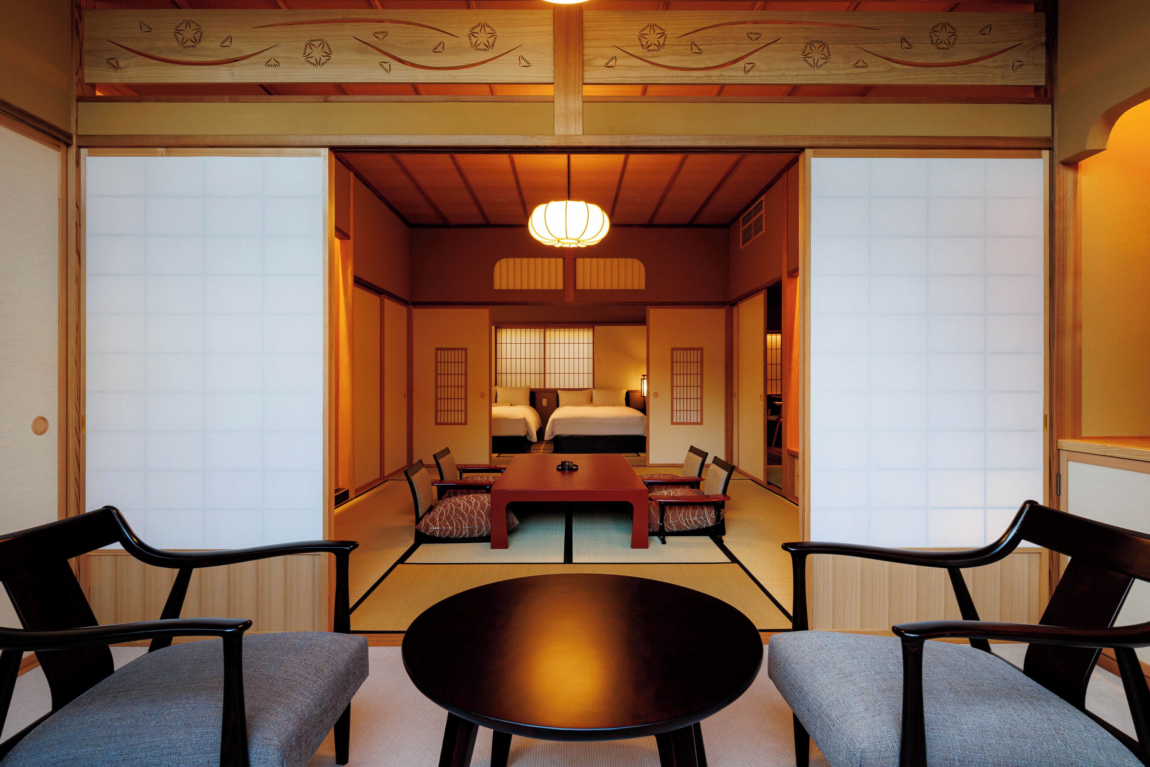 A traditional Japanese room with tatami flooring, a low wooden table, and shoji screens.