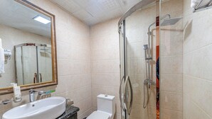 A bathroom with a sink, toilet, and shower. - Amar Hotel Ulaanbaatar live  (Ulaanbaatar)