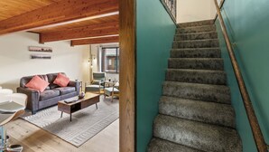 A staircase with a wooden handrail and carpeted steps, leading to an upper floor. - 2BR condo in West Yellowstone, just 1 minute from the park! Owl's Nest (West Yellowstone)