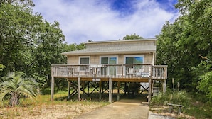 A two-story house with a wooden deck and a covered porch. - Shore 'Nuf - 3 BR Oceanside in Duck (Duck)