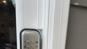 A door with a numeric keypad lock. - Stylish Decor Studio (Tega Cay)