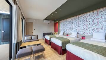 A modern hotel room with a large bed, two smaller beds, a sofa, and a bench.