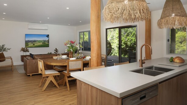 A modern kitchen with a large island, wooden furniture, and a view of greenery outside. - Saltwater Creek - immerse yourself in nature (Barringella)