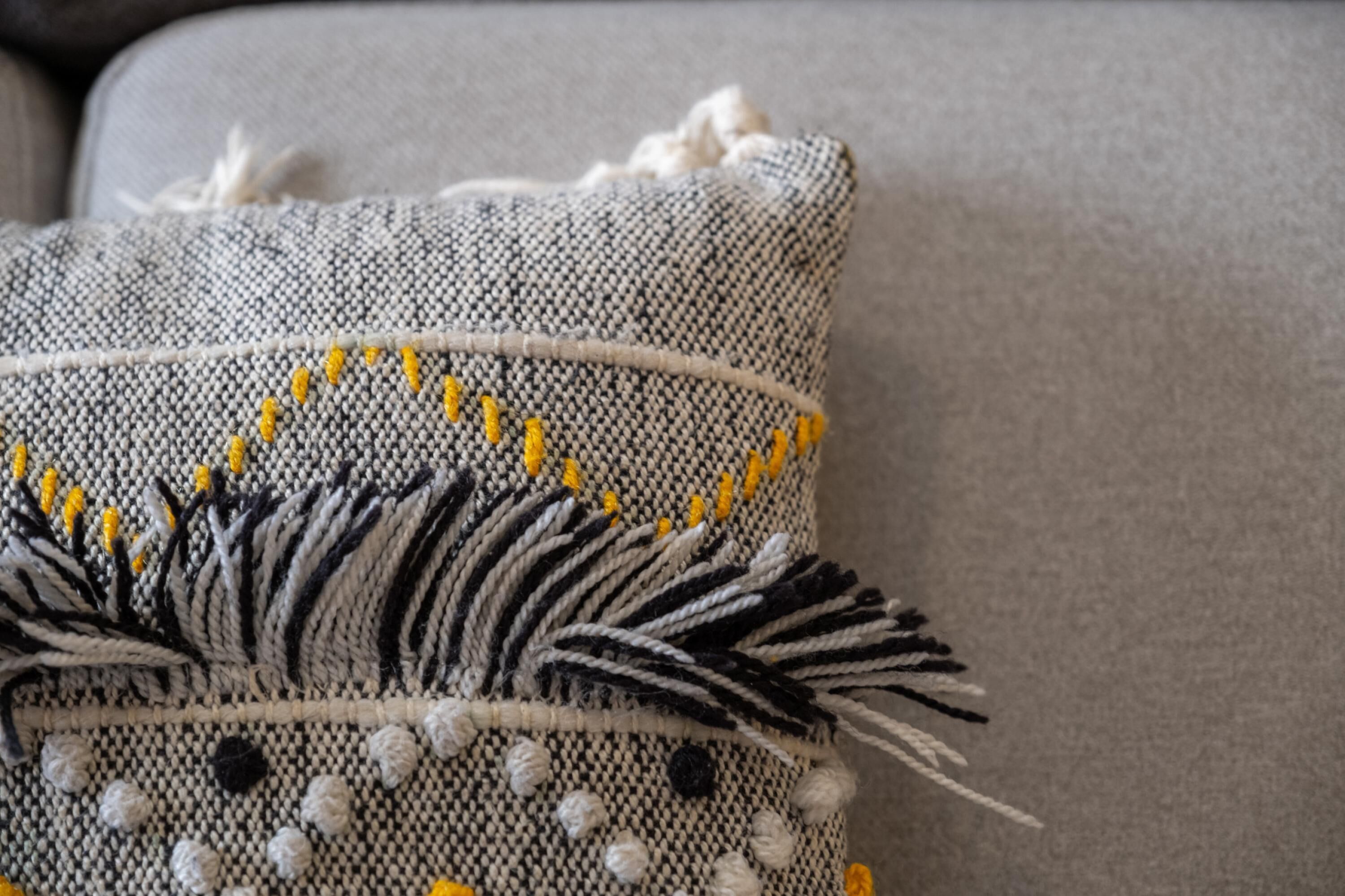 A close-up of a textured fabric with a woven pattern and decorative elements.