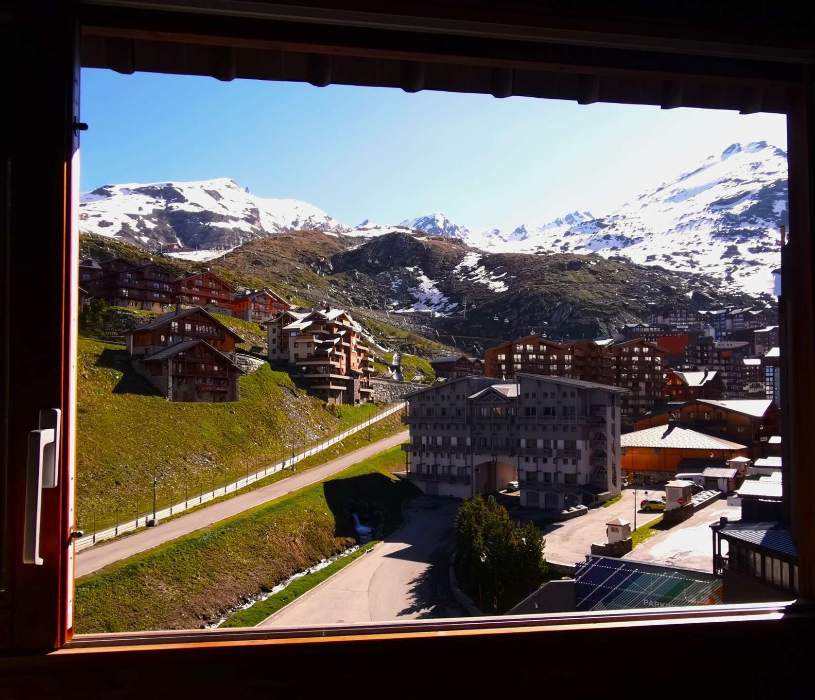 A mountain town with buildings and a road.