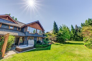 A two-story house with a hot tub in the front yard.