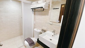 A bathroom with a shower, toilet, sink, and towel rack. - 3rd Alley Inn (Kaohsiung)