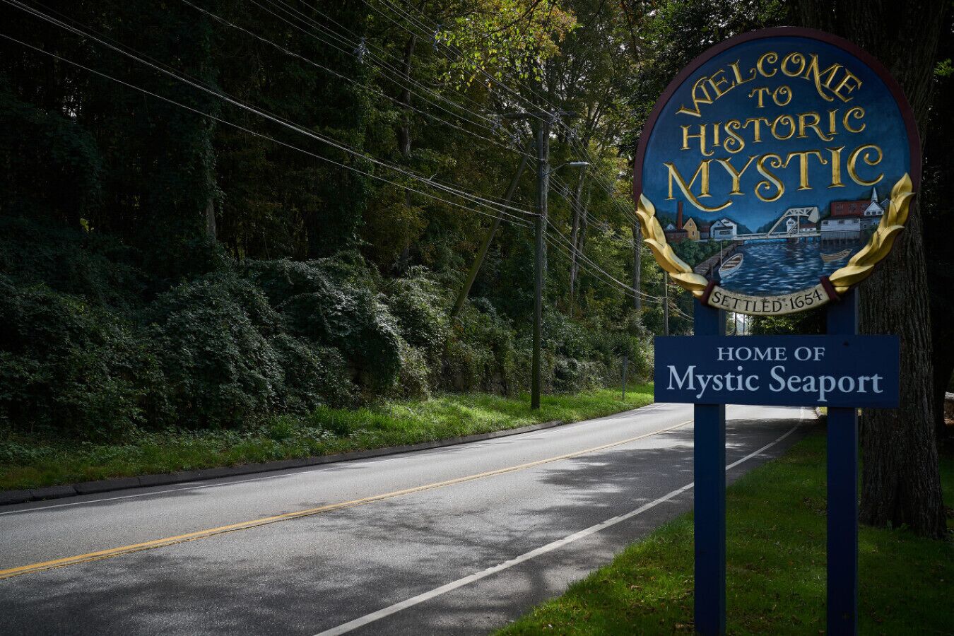 A welcome sign for Mystic Seaport, indicating it is the home of Mystic Seaport and established in 1654.
