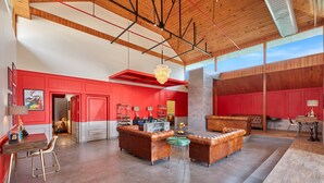 A spacious living area with a high ceiling, red walls, and a modern chandelier. - Fortune Park Palampur - Member ITC Hotels' Group (Palampur)