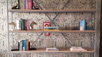 A bookshelf with multiple shelves, some books, and decorative items.