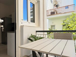 Enjoy a balcony with a table and chair, offering a view of the surrounding area.