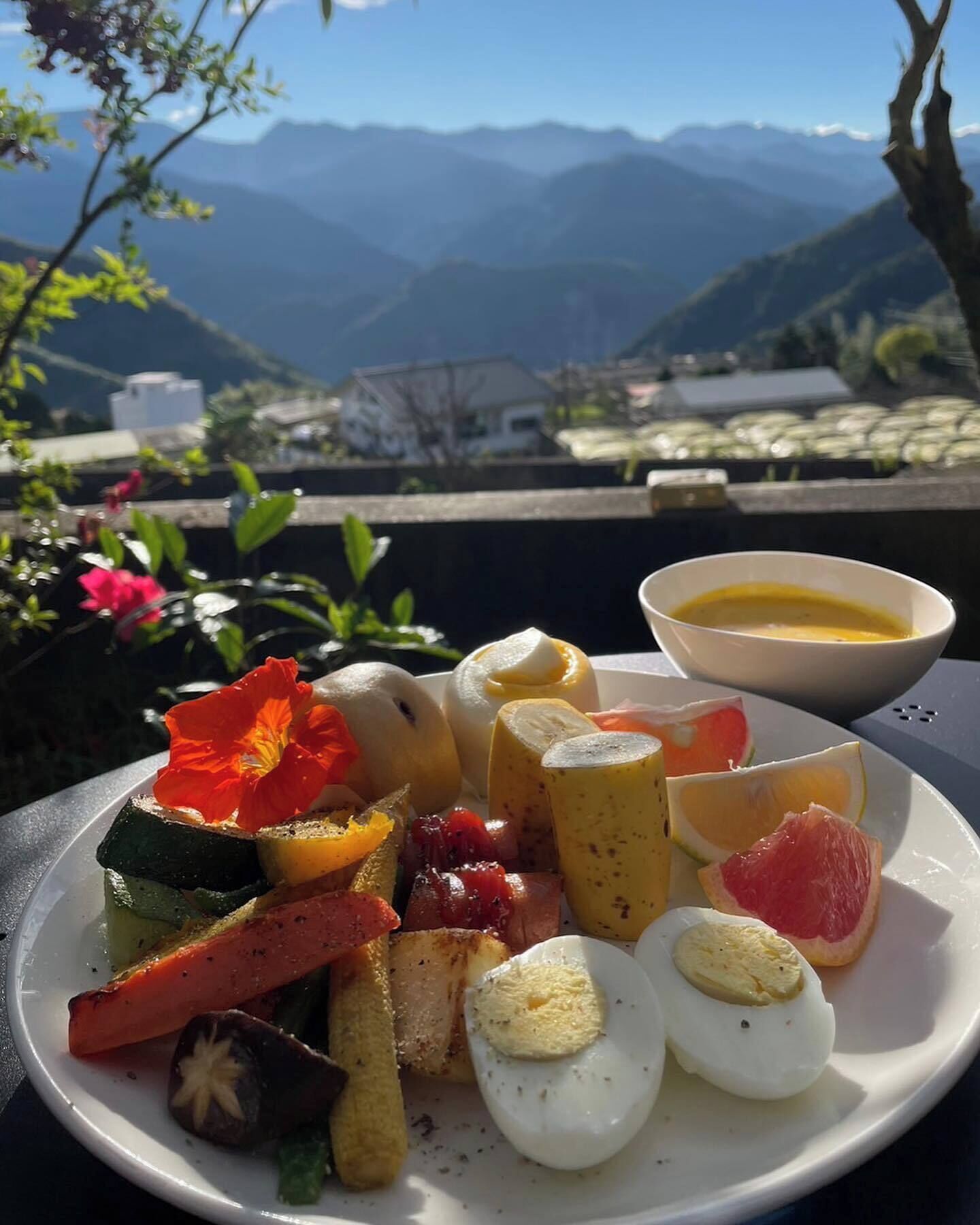 A plate of food with a view of mountains in the background.