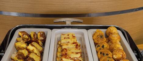 A tray with three sections containing different food items.