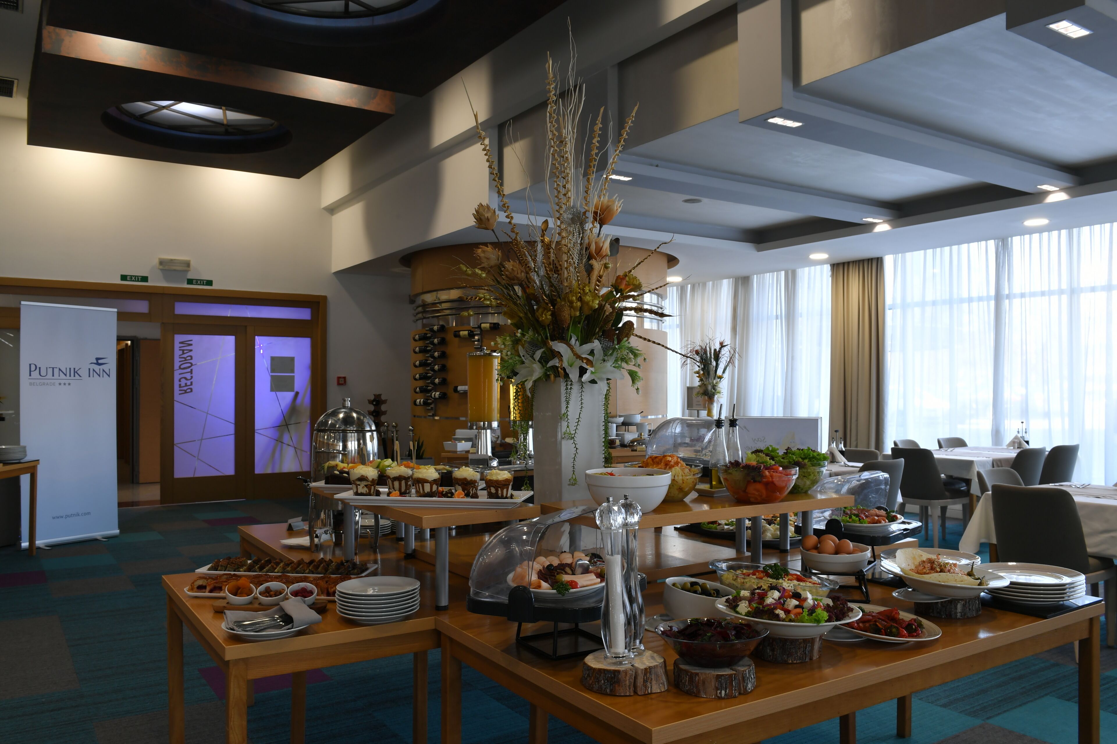 A buffet setup with various food items and a decorative centerpiece.