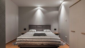 A modern bedroom with a large bed, nightstands, and a wardrobe. - Apartment Frankie's Place (Dubrovnik)