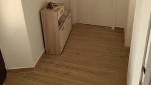 A hallway with wooden flooring and a wooden cabinet with drawers. - Holiday Home Katarina (Vinodol)