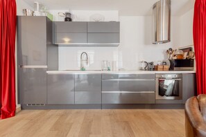 A modern kitchen with stainless steel appliances, a microwave, and a built-in oven.