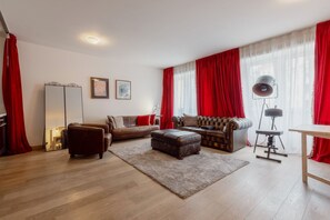 A living room with a sofa set, a coffee table, and a lamp.