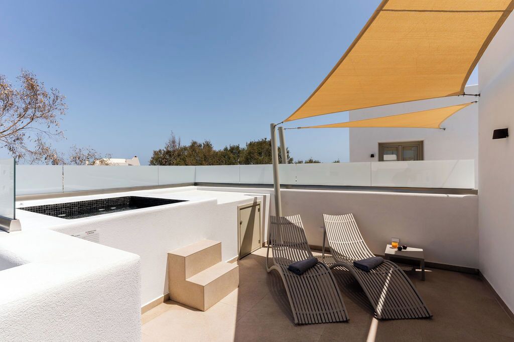 A rooftop terrace with a pool, lounge chairs, and a canopy.