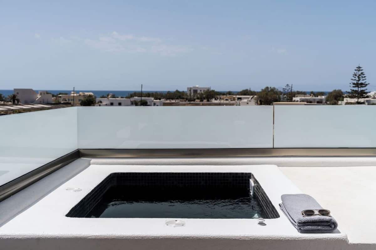 A rooftop pool with a clear view of the sea and surrounding buildings.