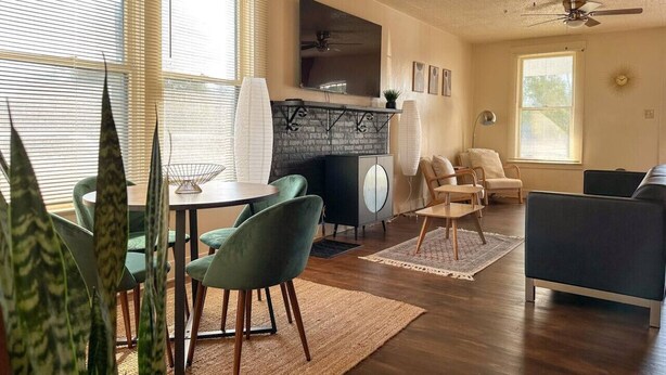A spacious living room with a dining area, a fireplace, and a ceiling fan. - Mid-Century Modern retreat (Visalia)
