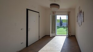 A hallway with a sliding glass door leading to a balcony. - ELYSIUM (Mazara del Vallo)