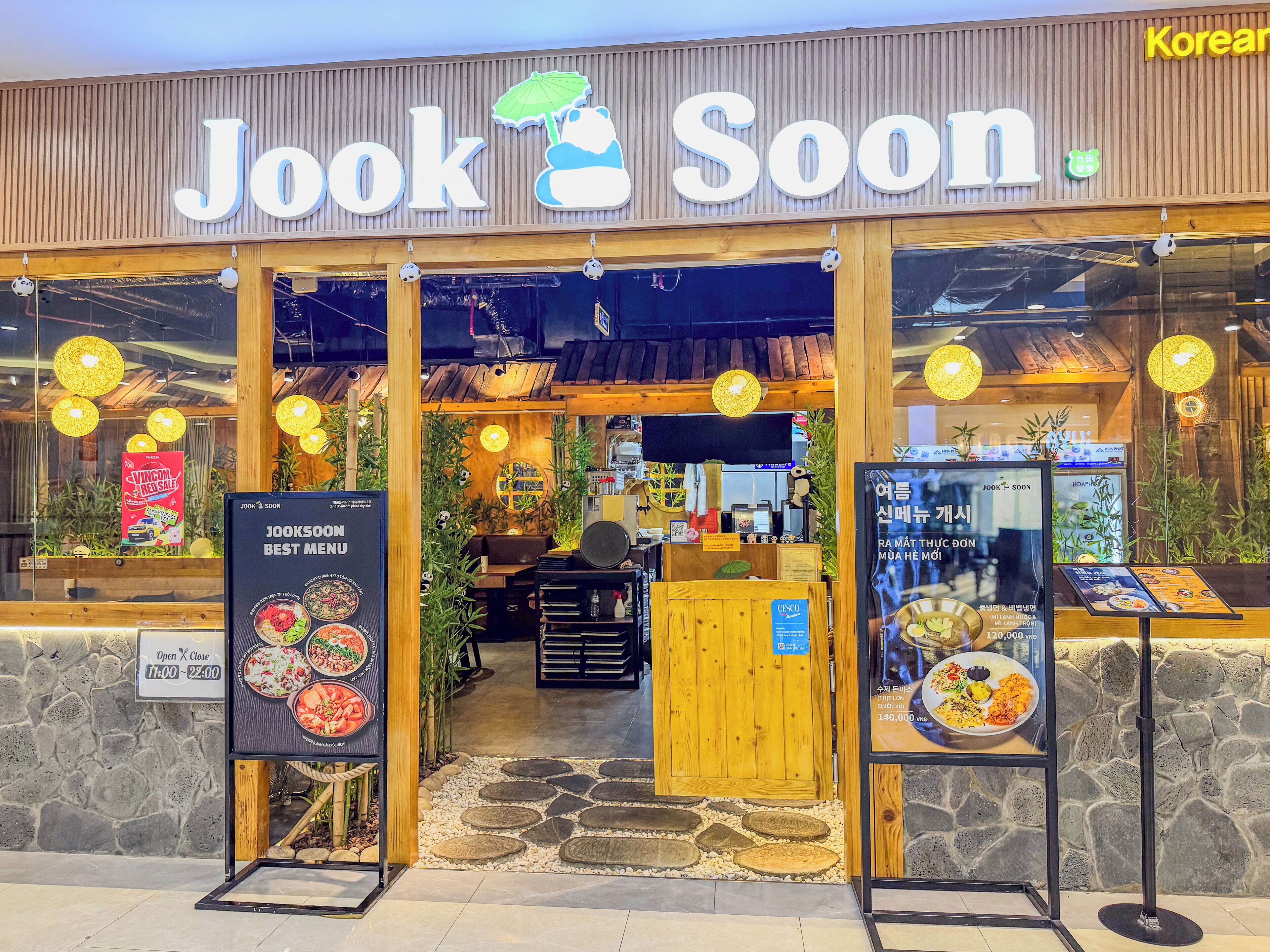 A restaurant named 'Jook Soon' with a wooden facade and large signage.