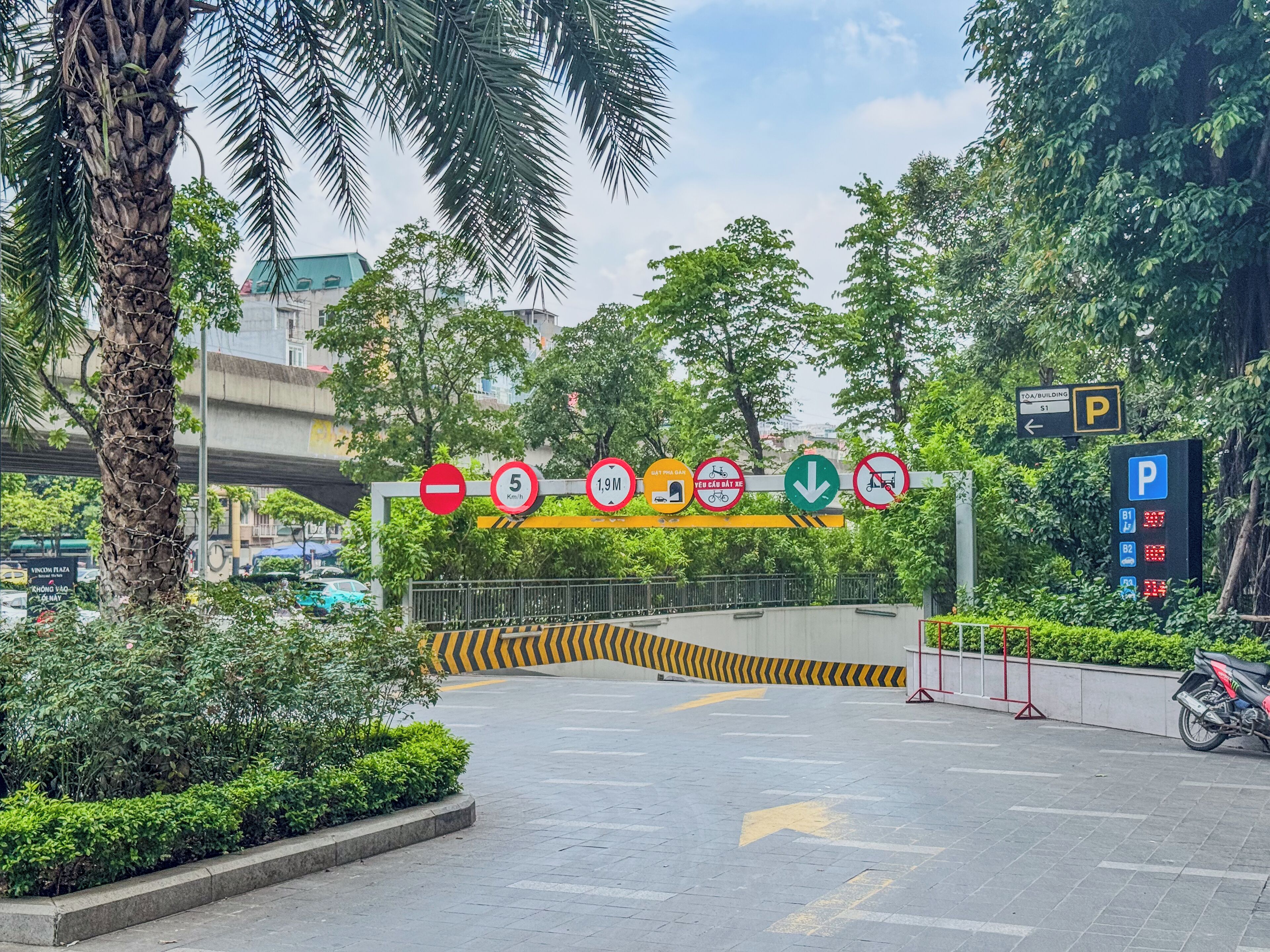 A parking area with multiple signs indicating parking restrictions and directions.