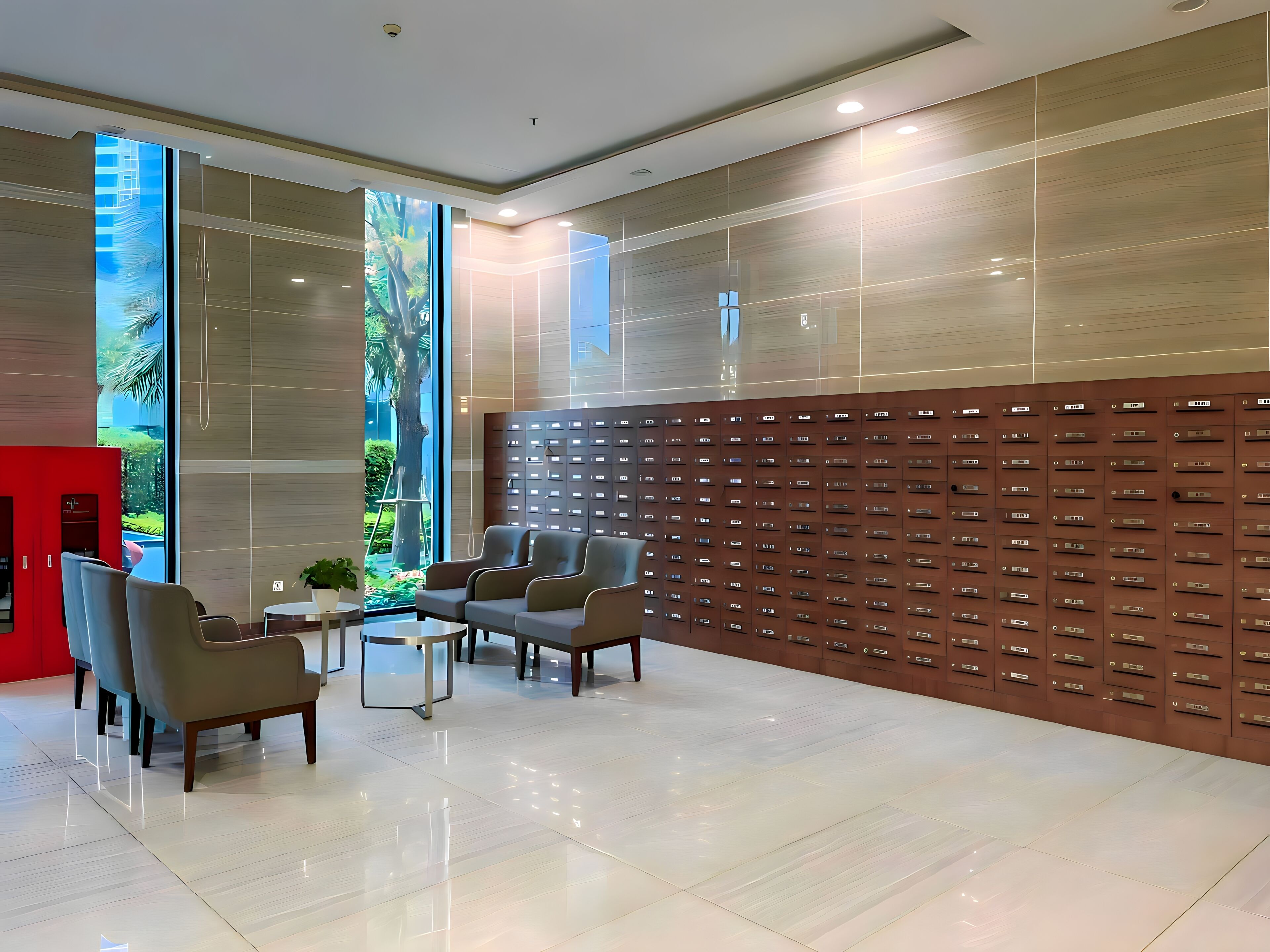 A modern lobby with a seating area, a wall of lockers, and a large window with a view of greenery.