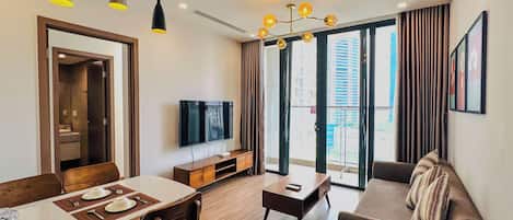 Signature Apartment, 1 King Bed, Balcony, City View, High Floor (15th floor above) | Living area | 60-inch Smart TV with cable channels, pay movies