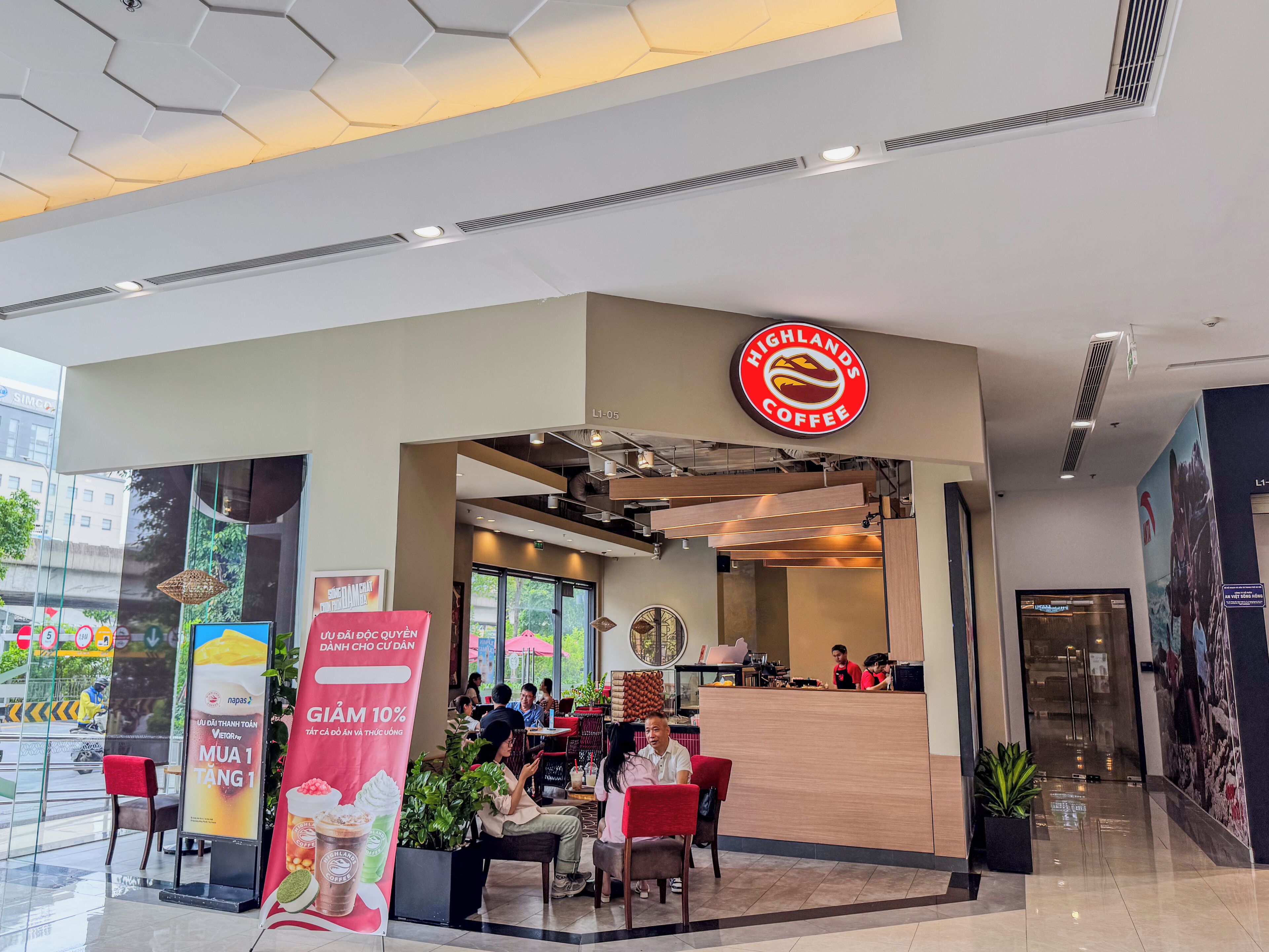 A coffee shop with a modern interior, a visible counter, and seating area.