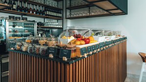A buffet area with various food items and condiments. - Regency  Boutique  Hotel (Paphos)
