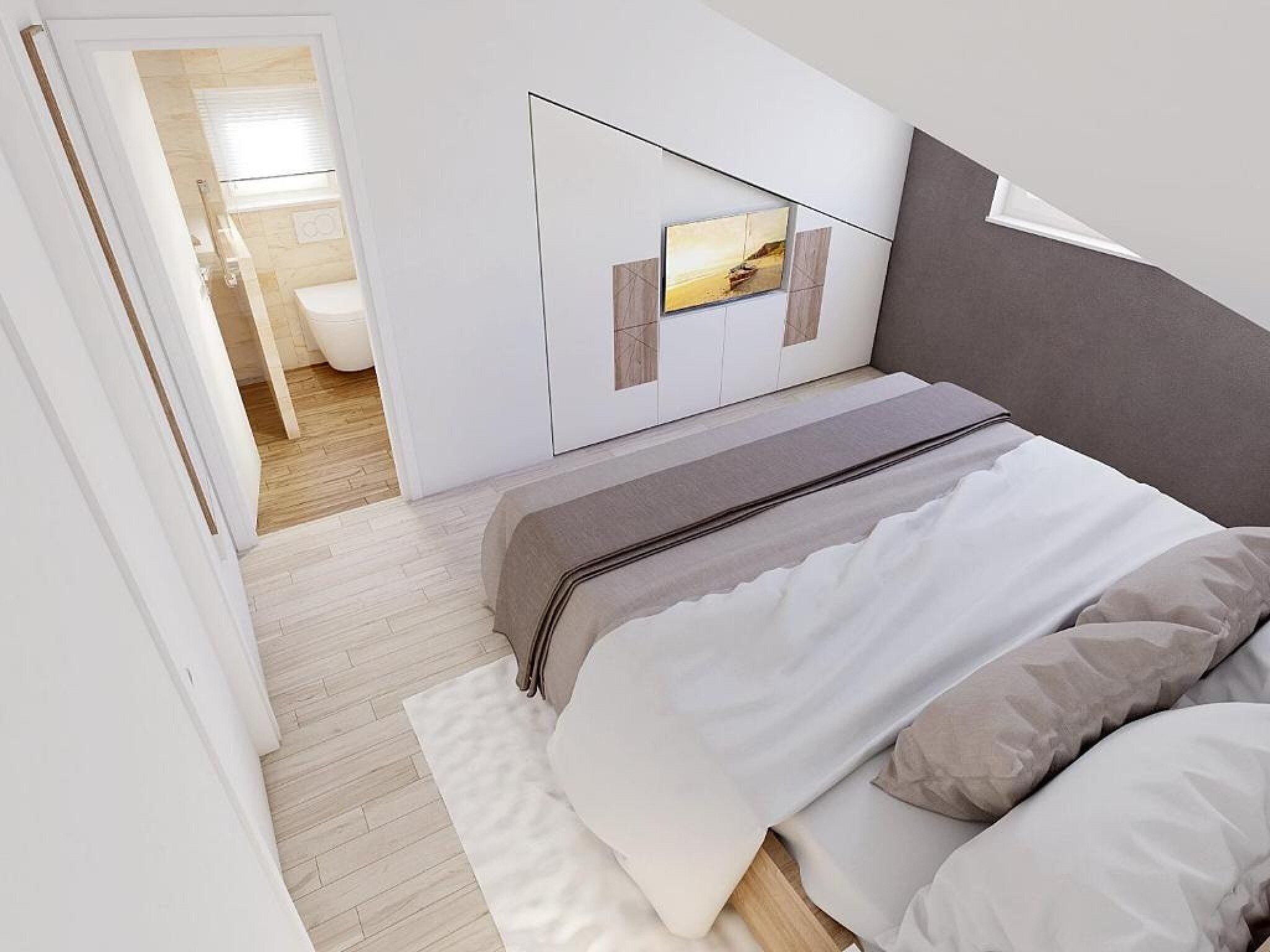 A bedroom with a bed, a bedside table, and a wall-mounted TV.