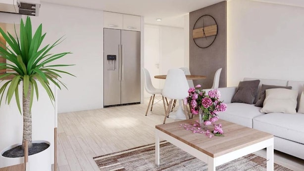 A modern living room with a white sofa, a wooden coffee table, and a dining area with white chairs. - Apartments Villa Subic (Rab)