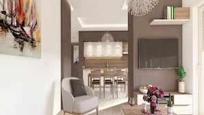 A modern living room with a dining area, a kitchen in the background, and a large abstract painting on the wall. - Apartments Villa Subic (Rab)