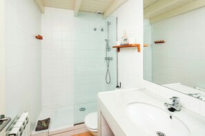 Shower, hair dryer, towels, toilet paper