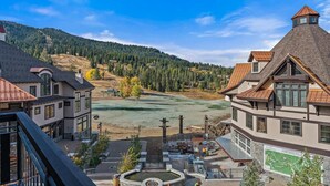 A residential area with a view of a golf course, a pond, and a mountain backdrop. - Whispering Pines| Includes Two 1-Day Lift Tickets (Tamarack)