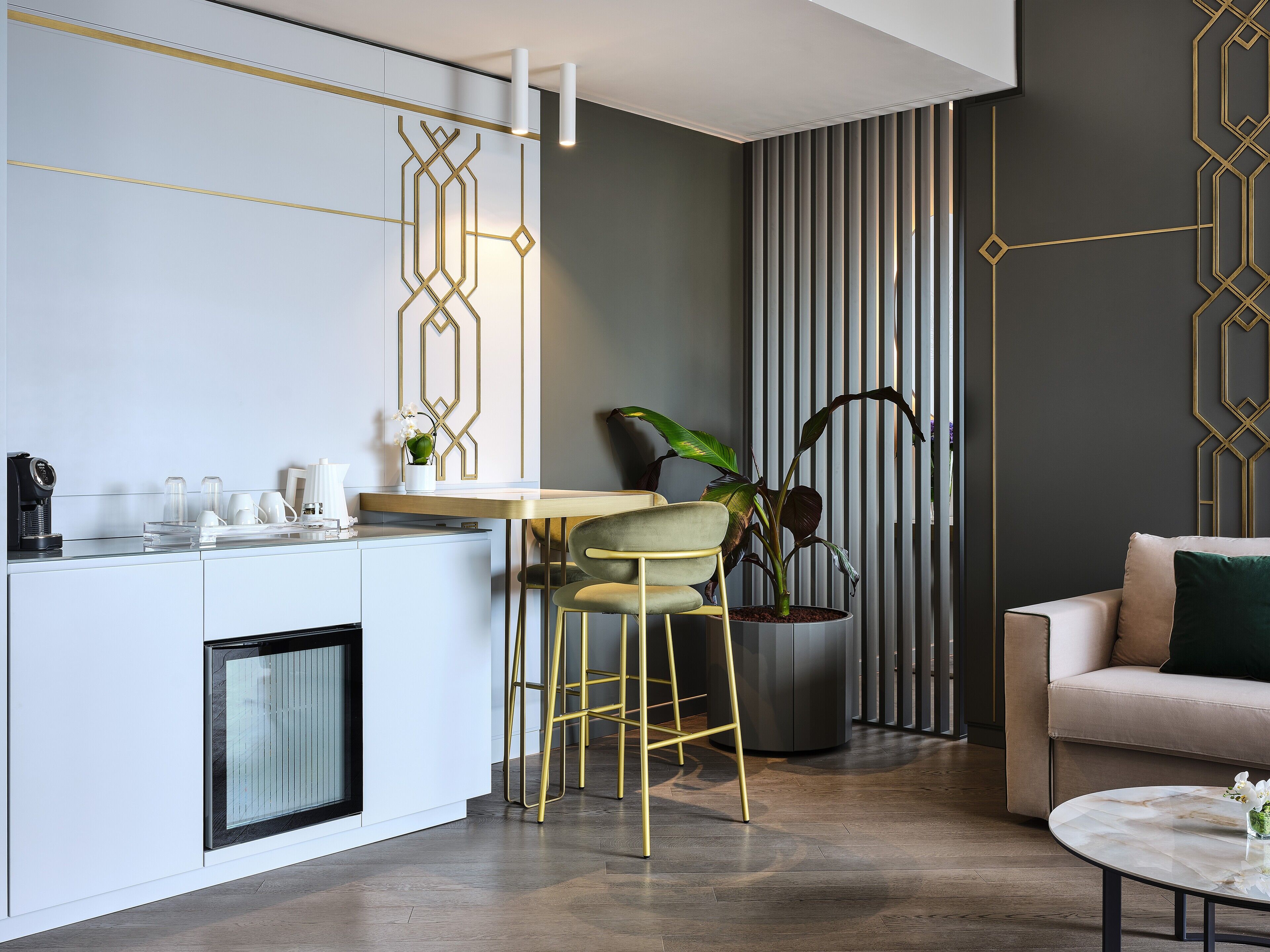 A modern kitchen with a dining area, a sofa, and a coffee table.