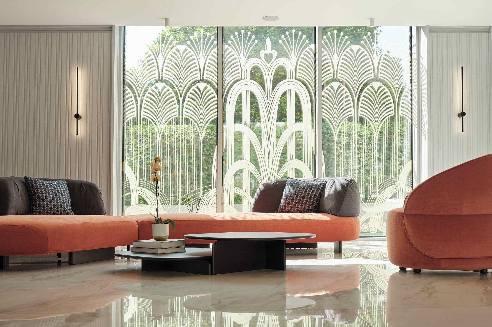 Un salon moderne doté d’une grande fenêtre, de deux canapés, d’une table basse et de panneaux décoratifs sur les murs.