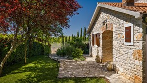 A stone house with a stone pathway leading to the entrance.