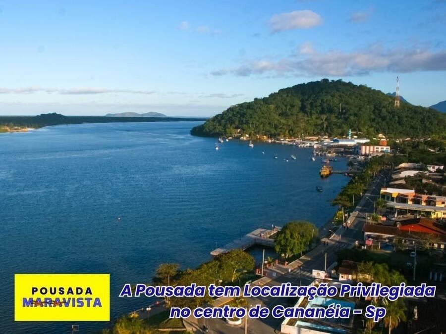 A coastal town with a prominent hill and a lighthouse.