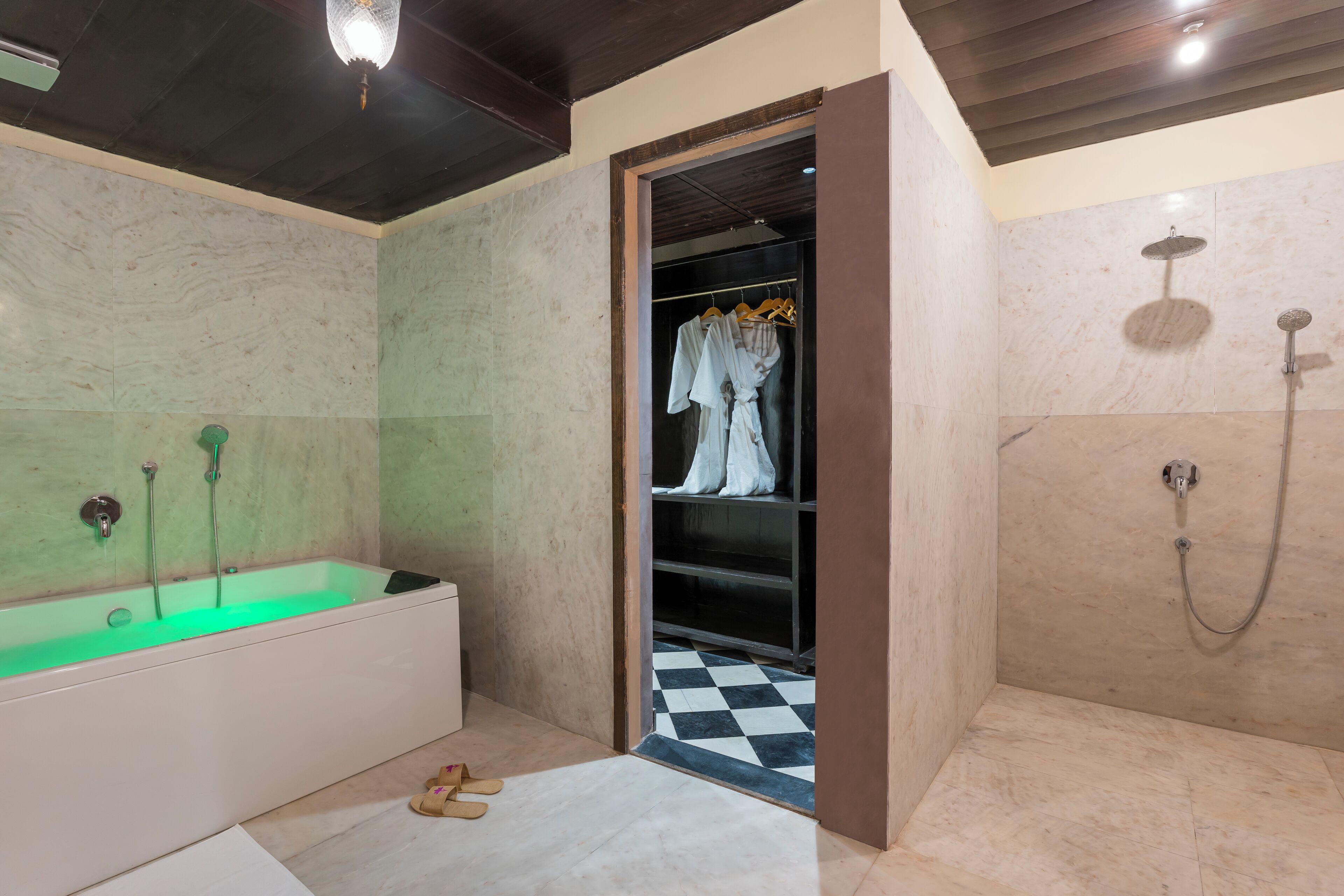A bathroom with a bathtub, a shower, and a walk-in closet.