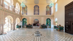 A spacious lobby with ornate arches, a central fountain, and patterned flooring. - Kesarbagh Palace (Chittorgarh)