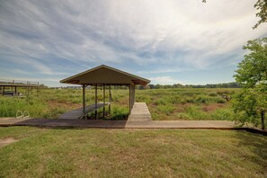 A gazebo with a concrete platform leading to it, surrounded by grassy fields and trees. - Yard, Deck & Fire Pit: Cedar Creek Reservoir Gem (Mabank)