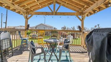Relax on the covered patio with comfortable seating and a scenic view.
