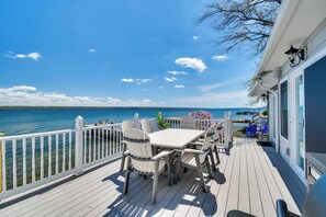 A deck with a table and chairs overlooking a body of water. - Waterfront Romulus Getaway w/ Private Dock! (Romulus)